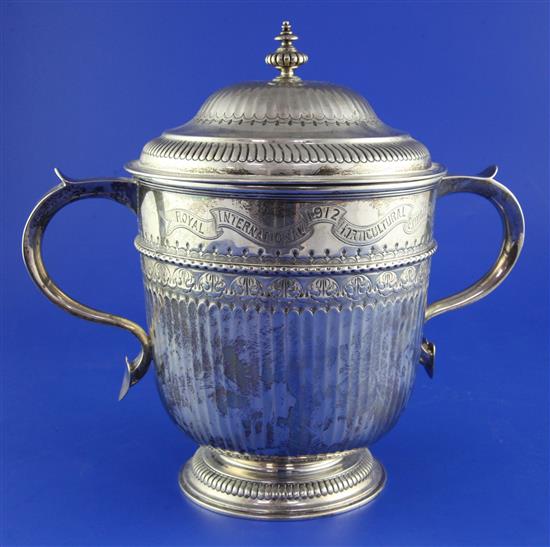 A George V silver two handled presentation cup and cover.